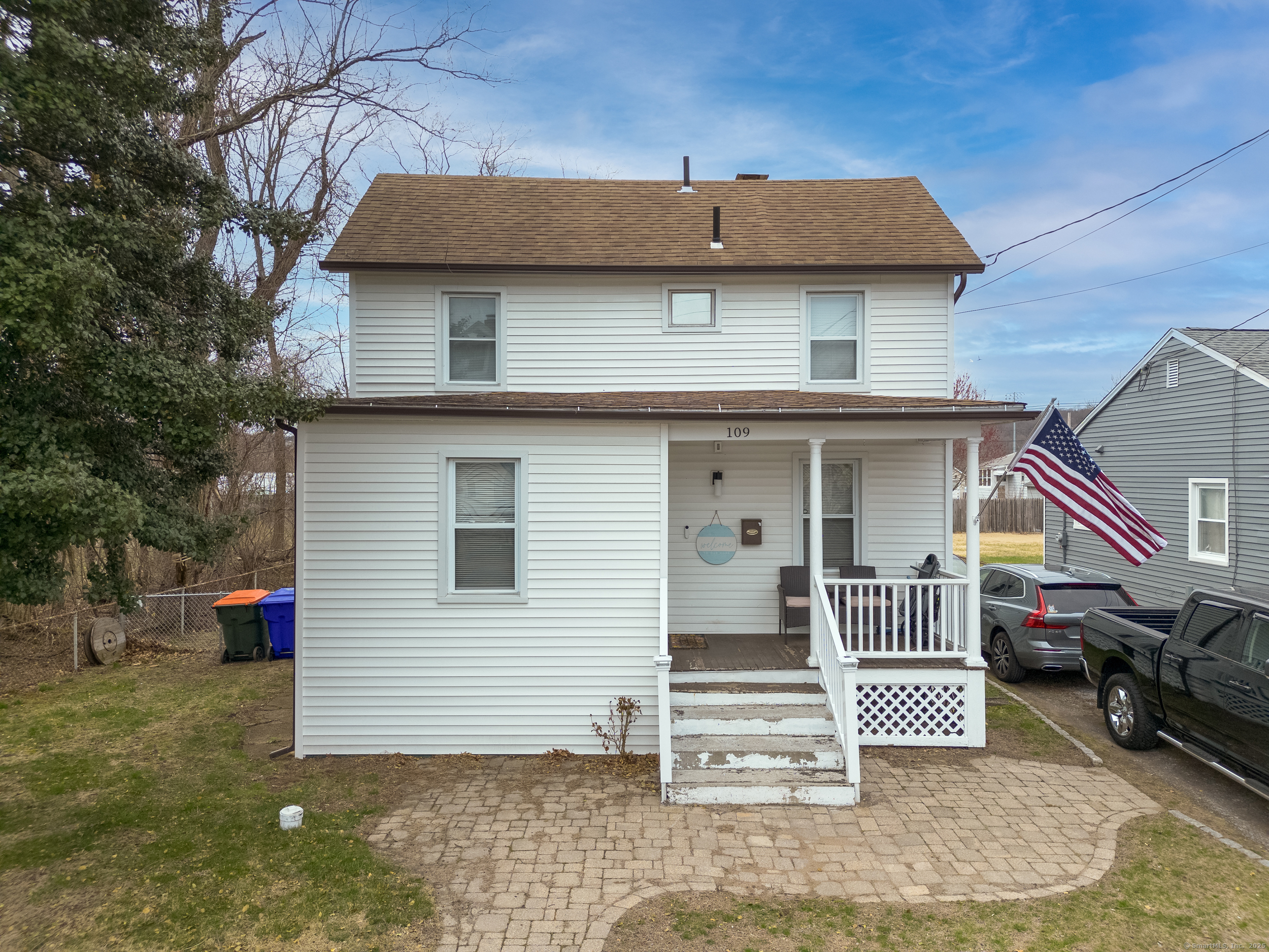 a view of a house with a patio and a yard