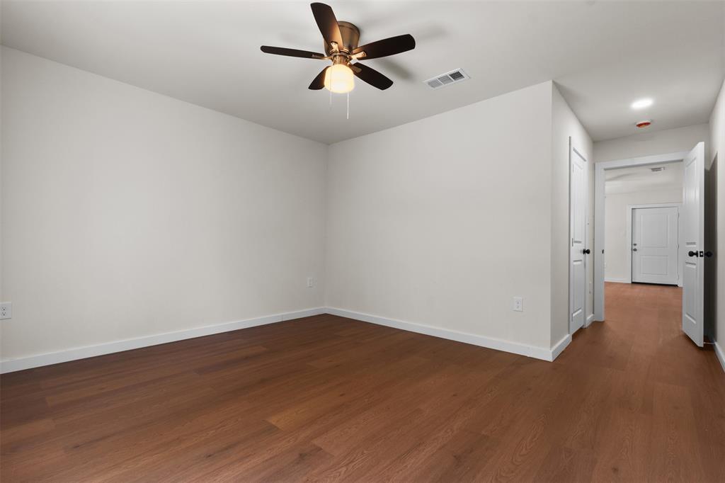 513 East Union Bower Road Irving, TX 75061 - Photo 21 of 34 Wood-finish flooring, white walls, and a ceiling fan with integrated lighting