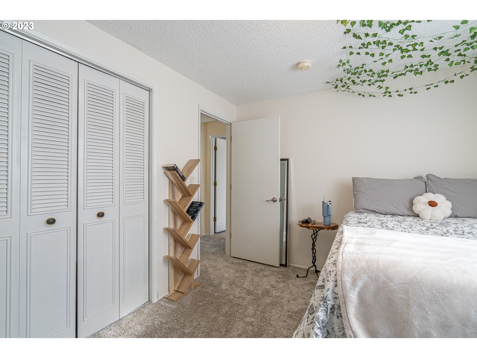28171 Clear Lake Road Eugene, OR 97402 - Photo 13 of 48 a bedroom with a bed and a chandelier