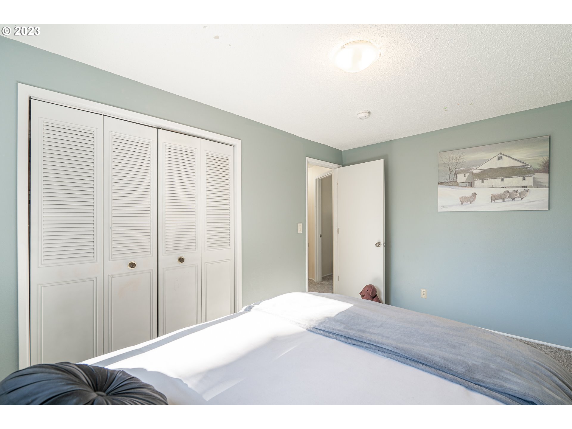 28171 Clear Lake Road Eugene, OR 97402 - Photo 15 of 48 a bedroom with a bed and a painting on the wall