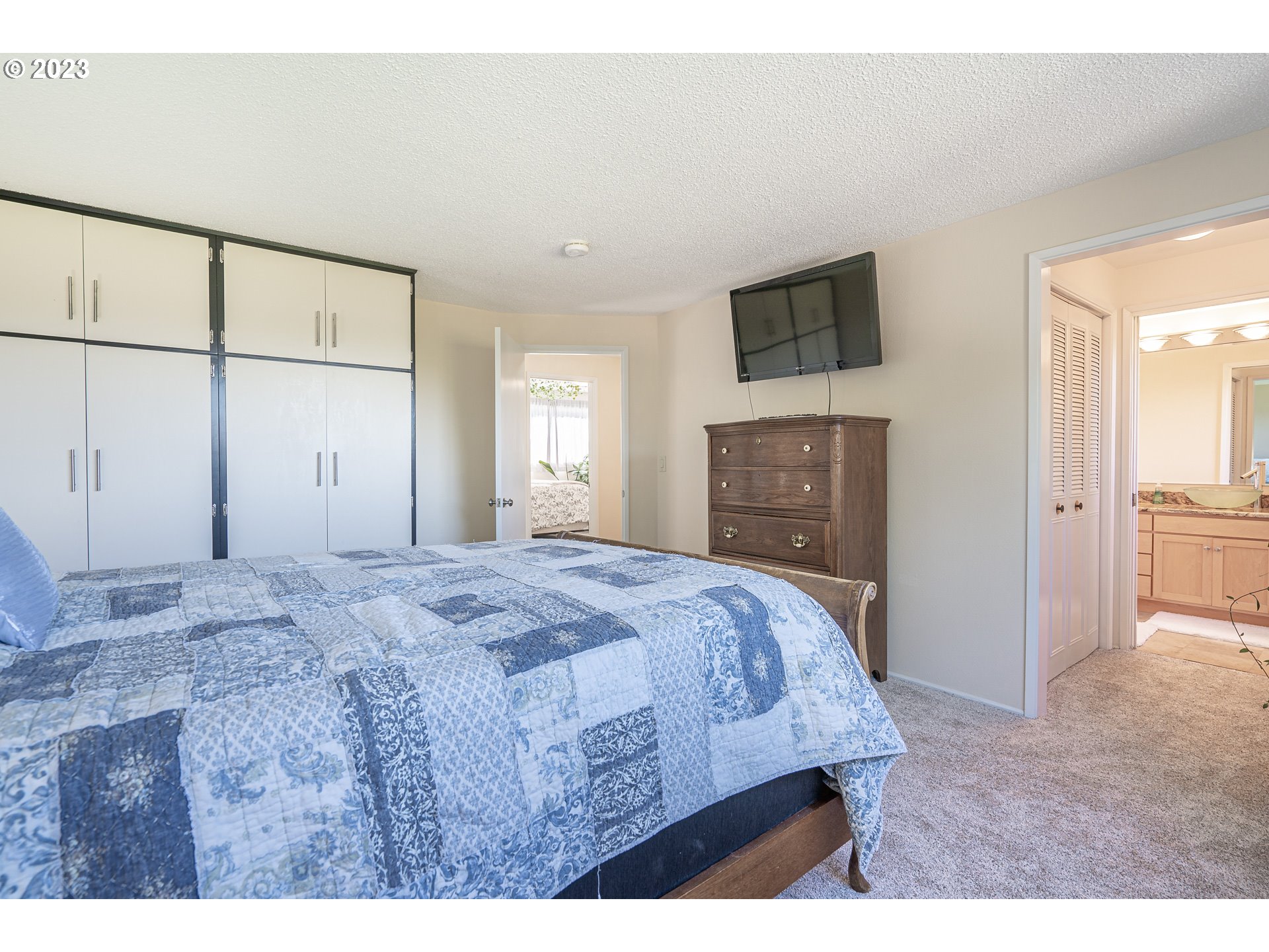 28171 Clear Lake Road Eugene, OR 97402 - Photo 16 of 48 a bedroom with a bed and a flat screen tv