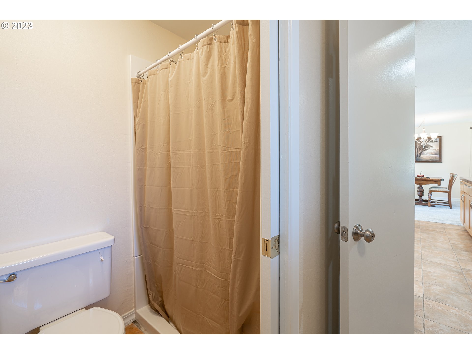 28171 Clear Lake Road Eugene, OR 97402 - Photo 9 of 48 a bathroom with a shower curtain and a toilet