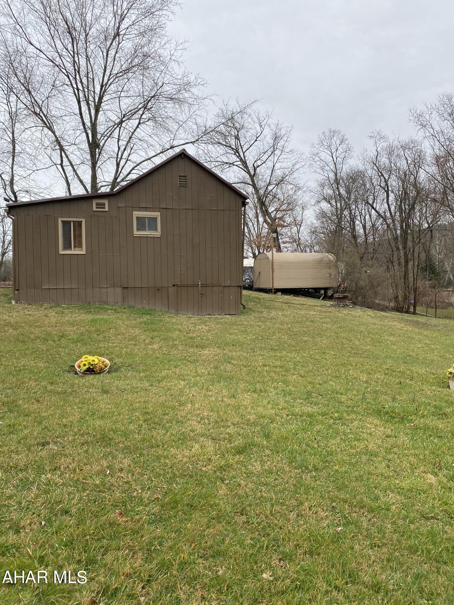 157 Stuckeysville Road Manns Choice, PA 15550 - Photo 22 of 28 a house view with a garden space
