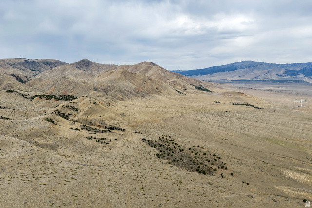12800 South Crooked Cyn Road South Elberta, UT 84626 - Photo 12 of 48 Expansive desert landscape featuring rolling hills and distant mountains under a cloudy sky