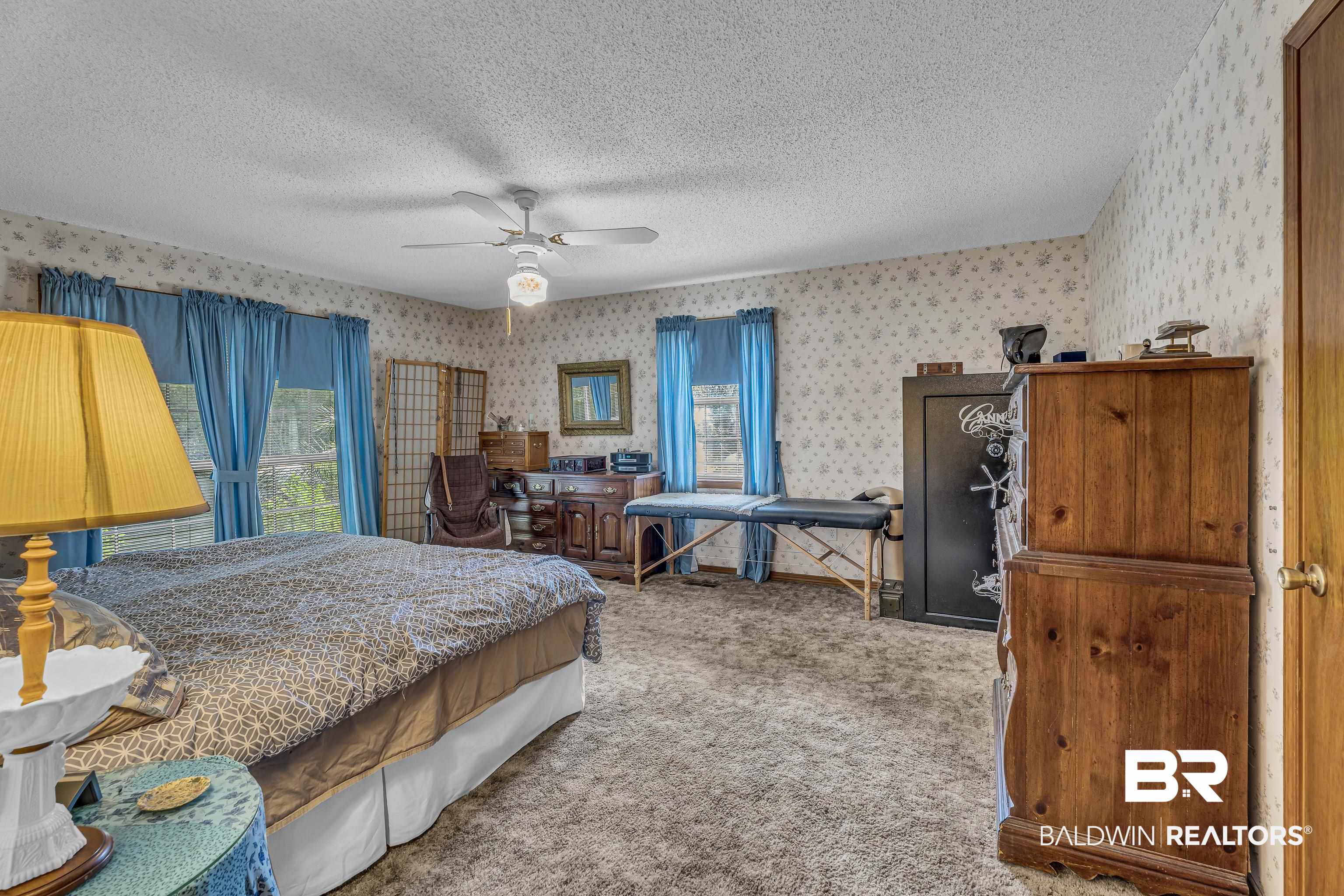 72075 Highway 59 Little River, AL 36550 - Photo 17 of 40 Bedroom with carpet floors, ceiling fan, a textured ceiling, and wallpapered walls