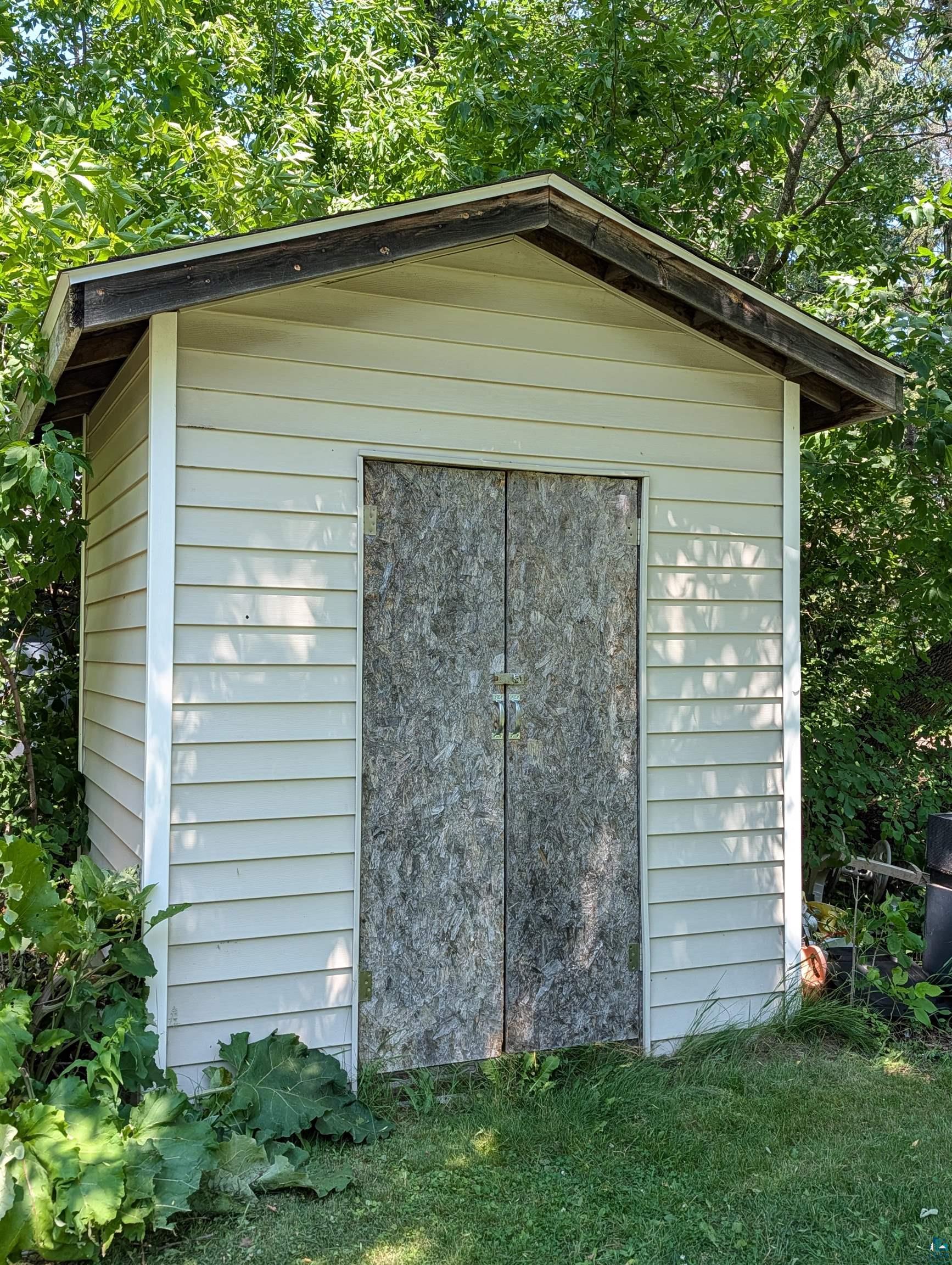 3945 Maple Street Kettle River, MN 55757 - Photo 41 of 41 Outdoor storage shed with light-colored horizontal siding and a dark-toned gable roof