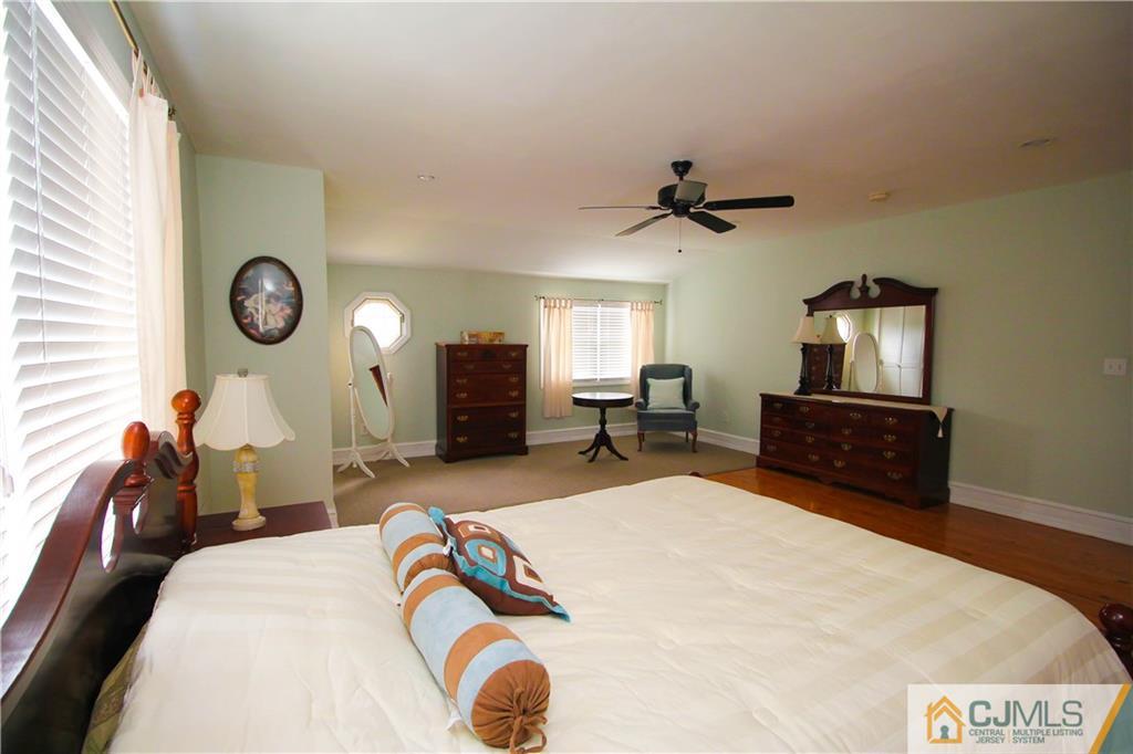 503 Crows Mill Road Fords, NJ 08863 - Photo 11 of 19 a bedroom with a bed and a chandelier