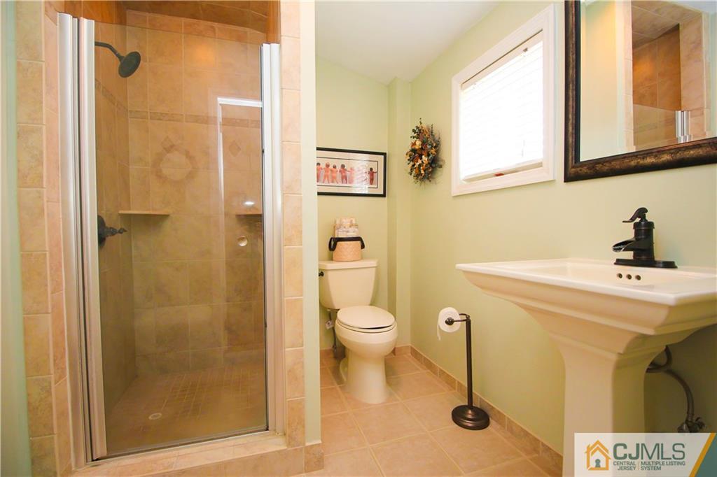 503 Crows Mill Road Fords, NJ 08863 - Photo 12 of 19 a bathroom with a toilet a sink and a shower