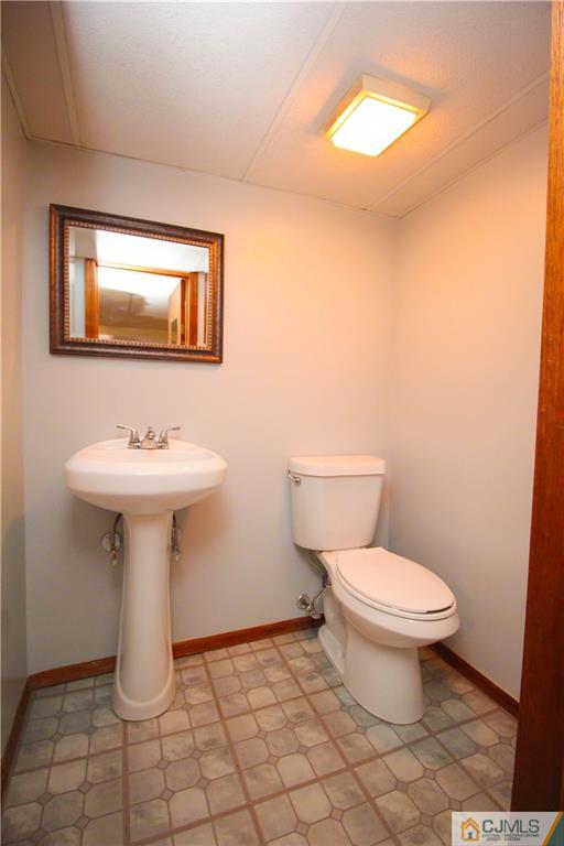 503 Crows Mill Road Fords, NJ 08863 - Photo 15 of 19 a bathroom with a sink toilet and mirror