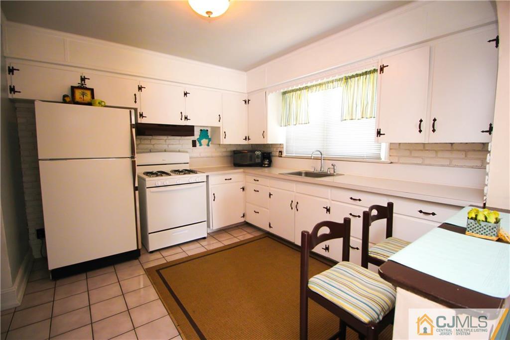 503 Crows Mill Road Fords, NJ 08863 - Photo 5 of 19 a kitchen with stainless steel appliances a stove a sink cabinets and a refrigerator