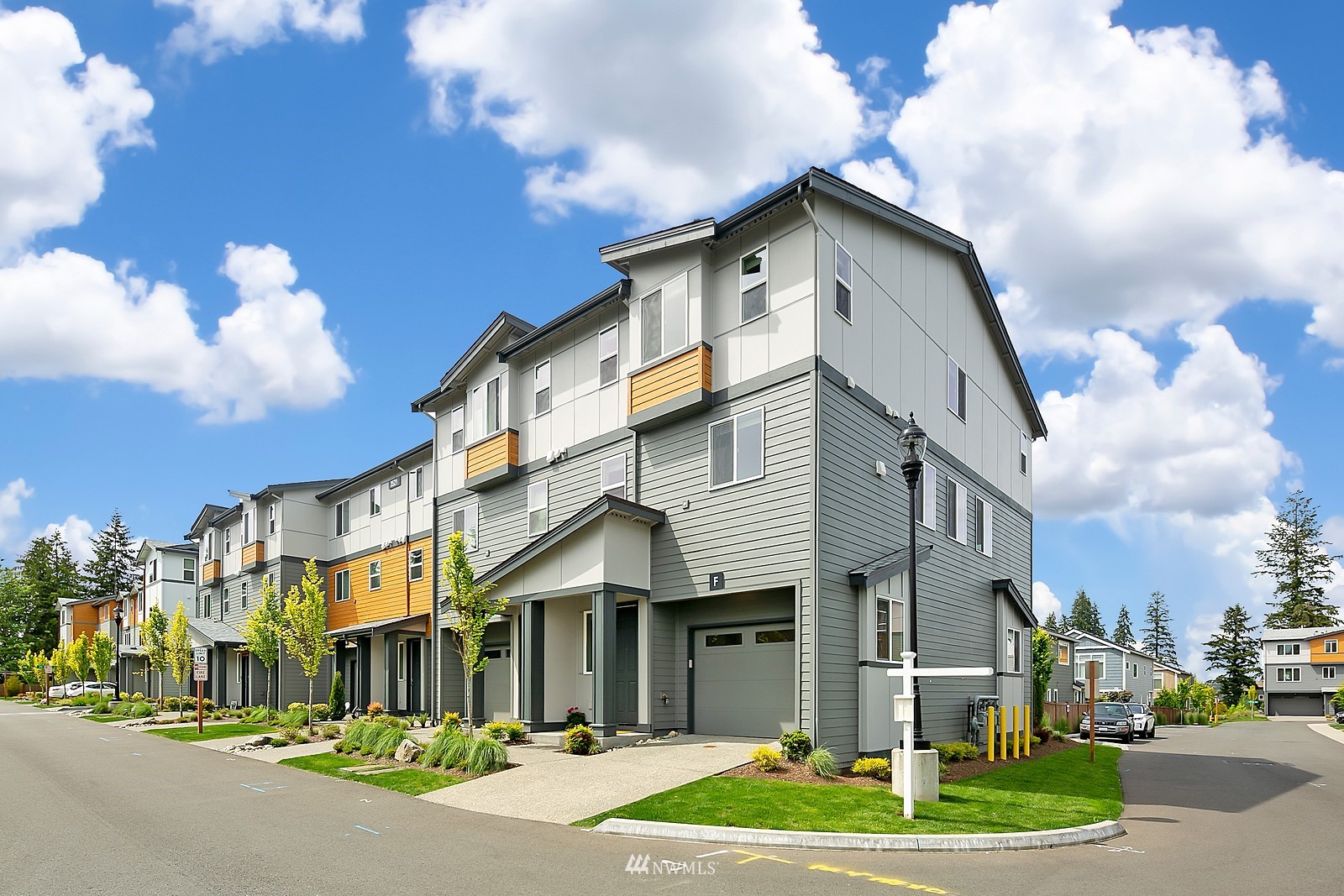 3521 193rd Street Southeast, Unit F Bothell, WA 98012 - Photo 2 of 29 a front view of a building with a garden