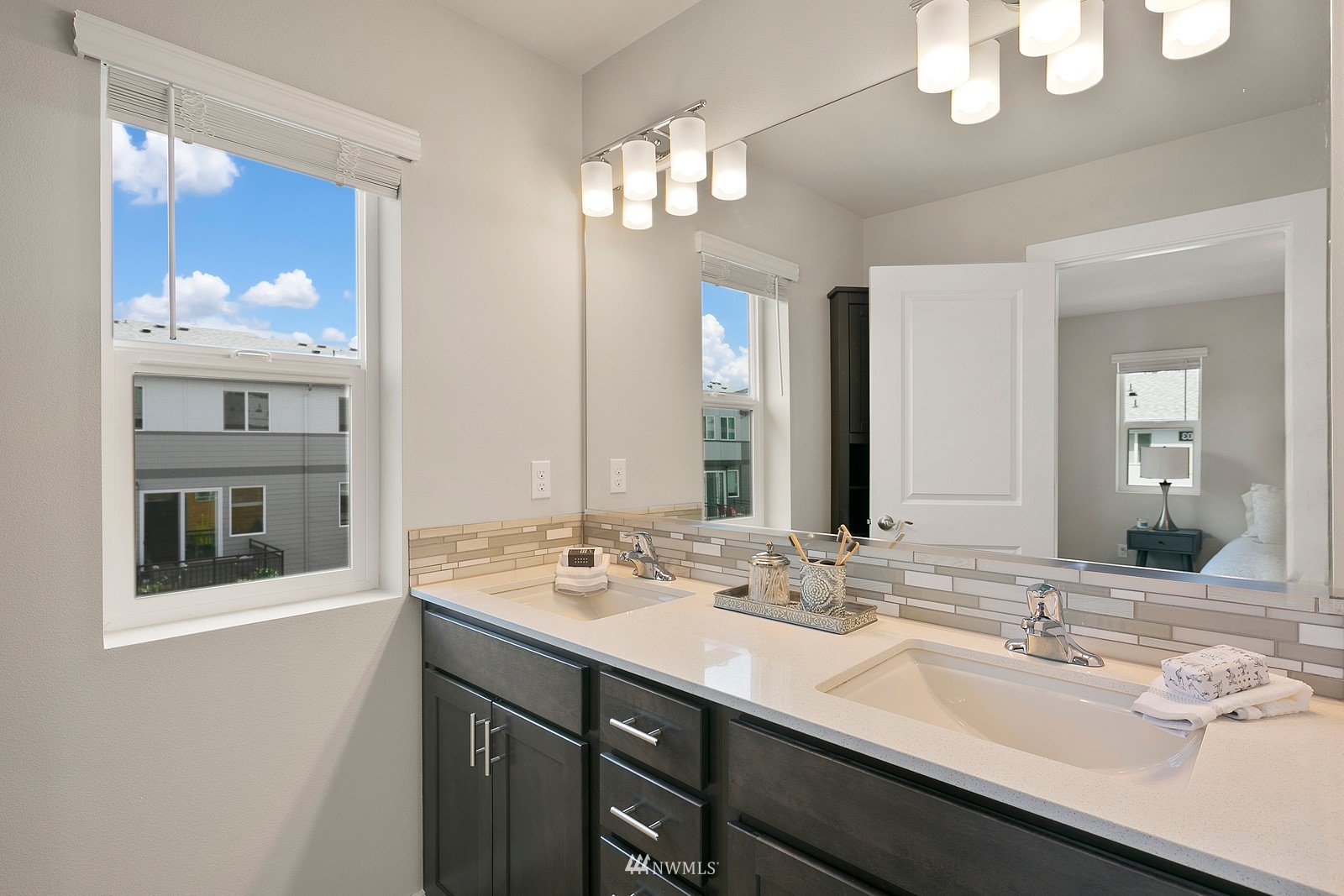 3521 193rd Street Southeast, Unit F Bothell, WA 98012 - Photo 21 of 29 a bathroom with a sink a large mirror and a light fixture