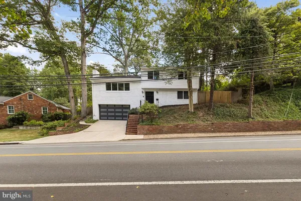 front view of house with a tree in front of it