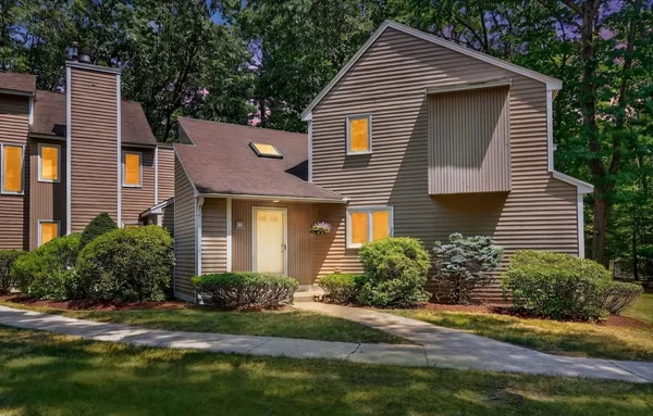 a front view of a house with a yard and outdoor seating