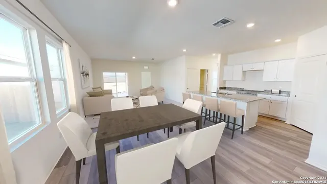 a large kitchen with a table and chairs