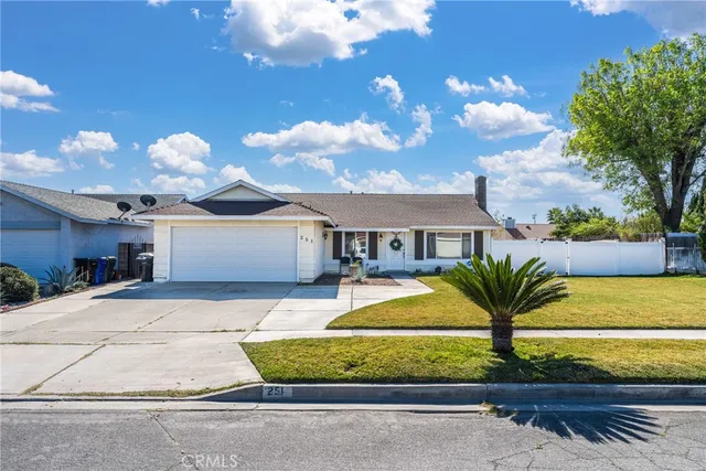 a front view of a house with a garden and plants