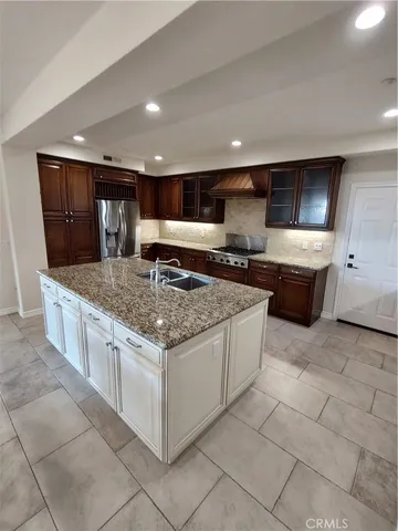 a kitchen with stainless steel appliances granite countertop a sink counter space and cabinets