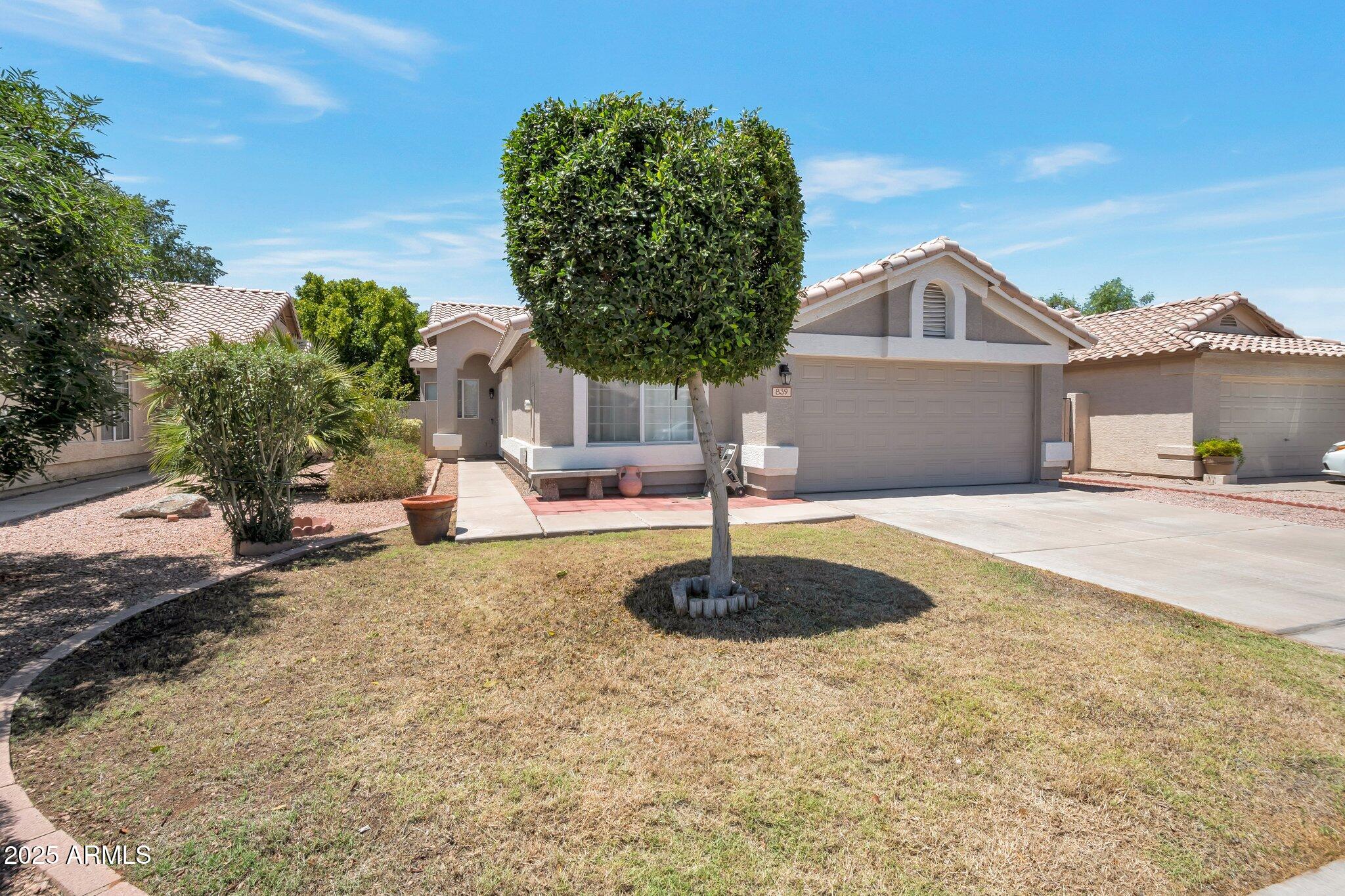839 West Silver Creek Road Gilbert, AZ 85233 - Photo 13 of 15 a front view of a house with a yard and garage