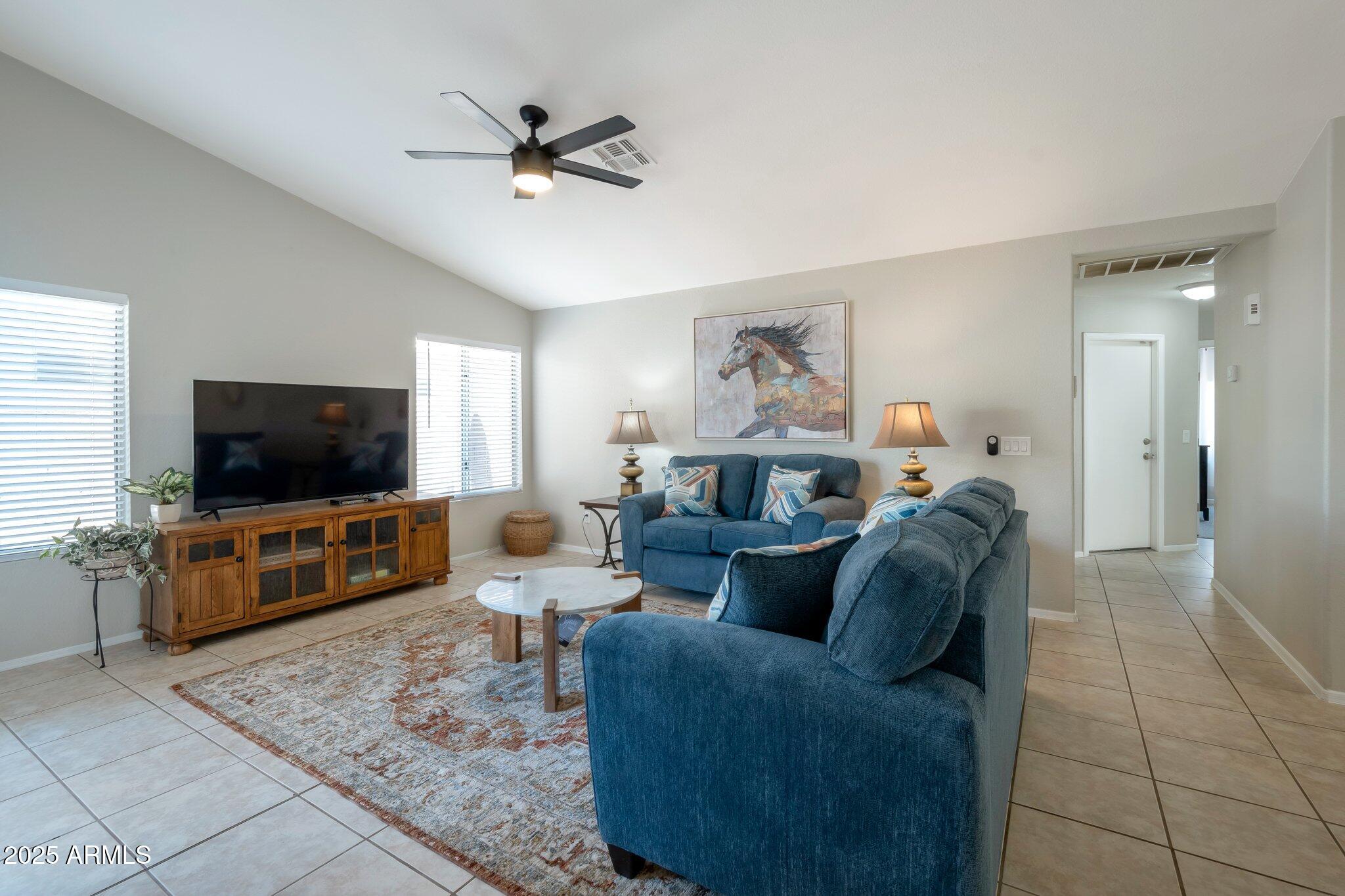 839 West Silver Creek Road Gilbert, AZ 85233 - Photo 6 of 15 a living room with furniture and a flat screen tv