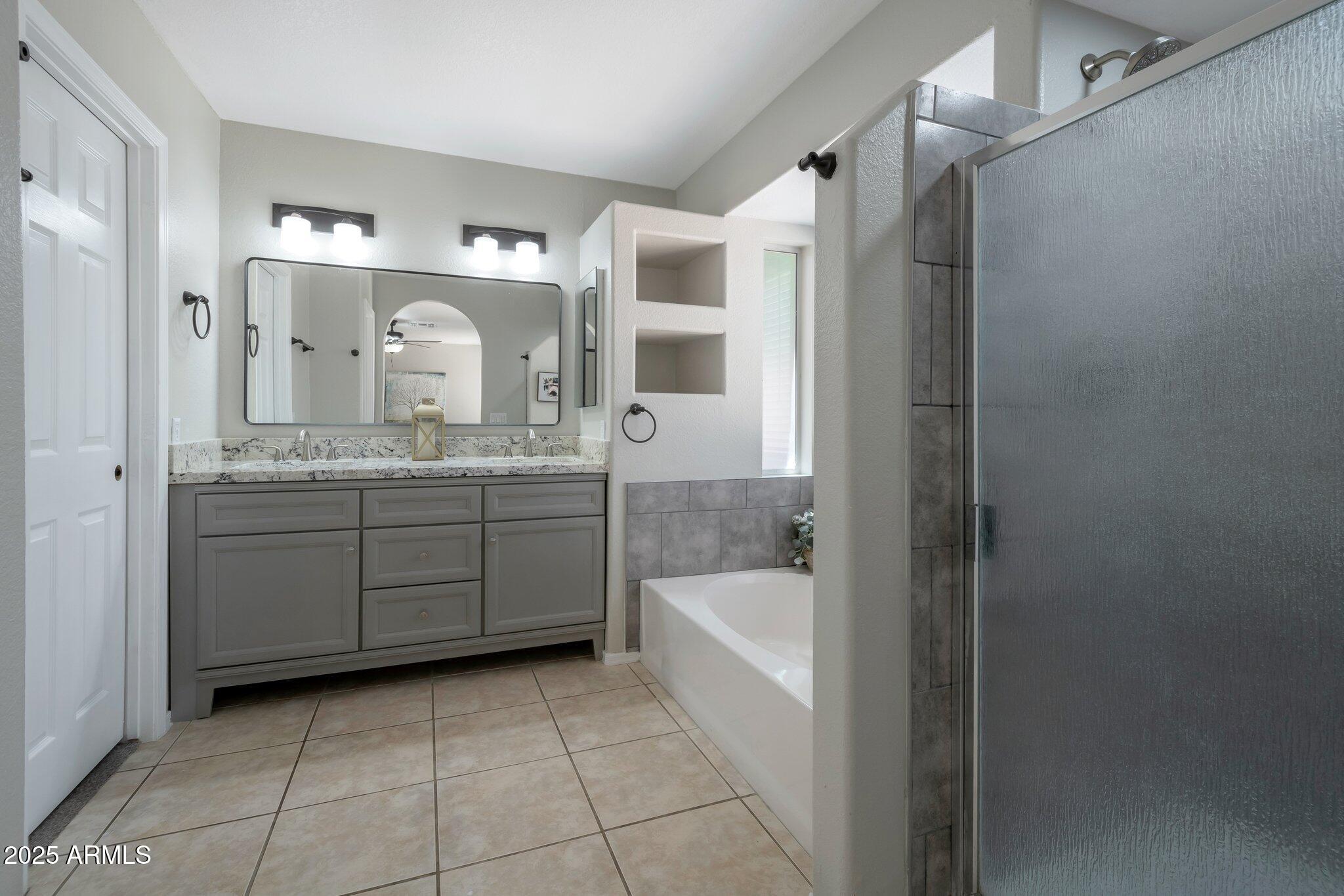 839 West Silver Creek Road Gilbert, AZ 85233 - Photo 8 of 15 a spacious bathroom with a granite countertop sink a mirror and shower