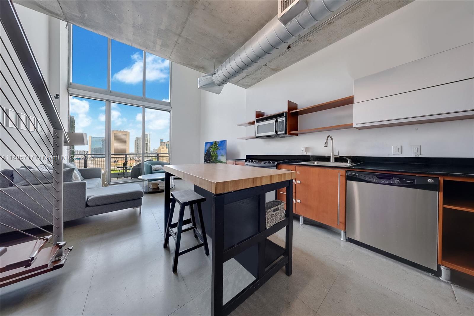 690 Southwest 1st Court, Unit 2109 Miami, FL 33130 - Photo 5 of 13 a kitchen with stainless steel appliances granite countertop a stove a sink dishwasher and cabinets with wooden floor
