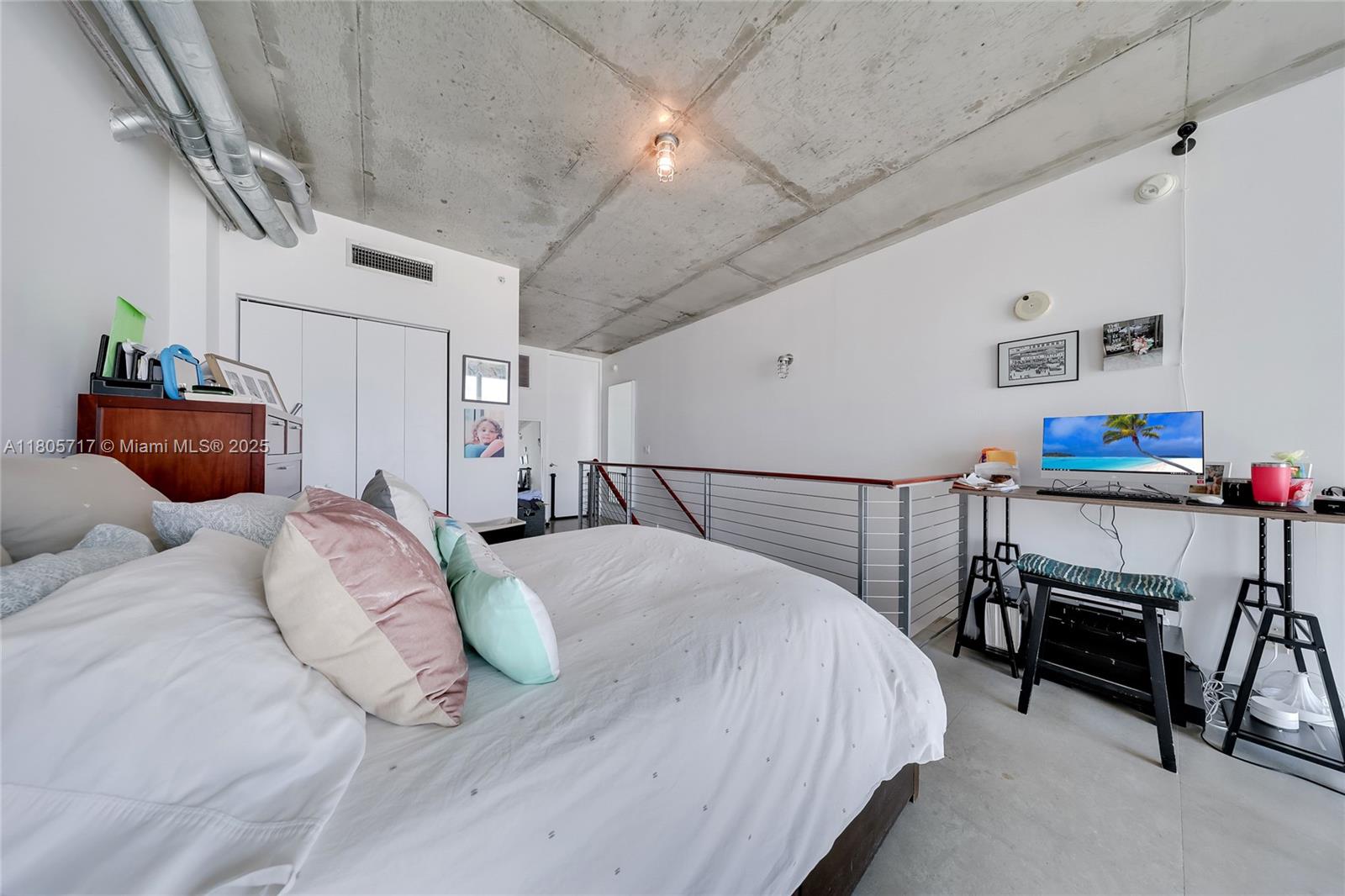 690 Southwest 1st Court, Unit 2109 Miami, FL 33130 - Photo 9 of 13 a bedroom with a bed and a chandelier