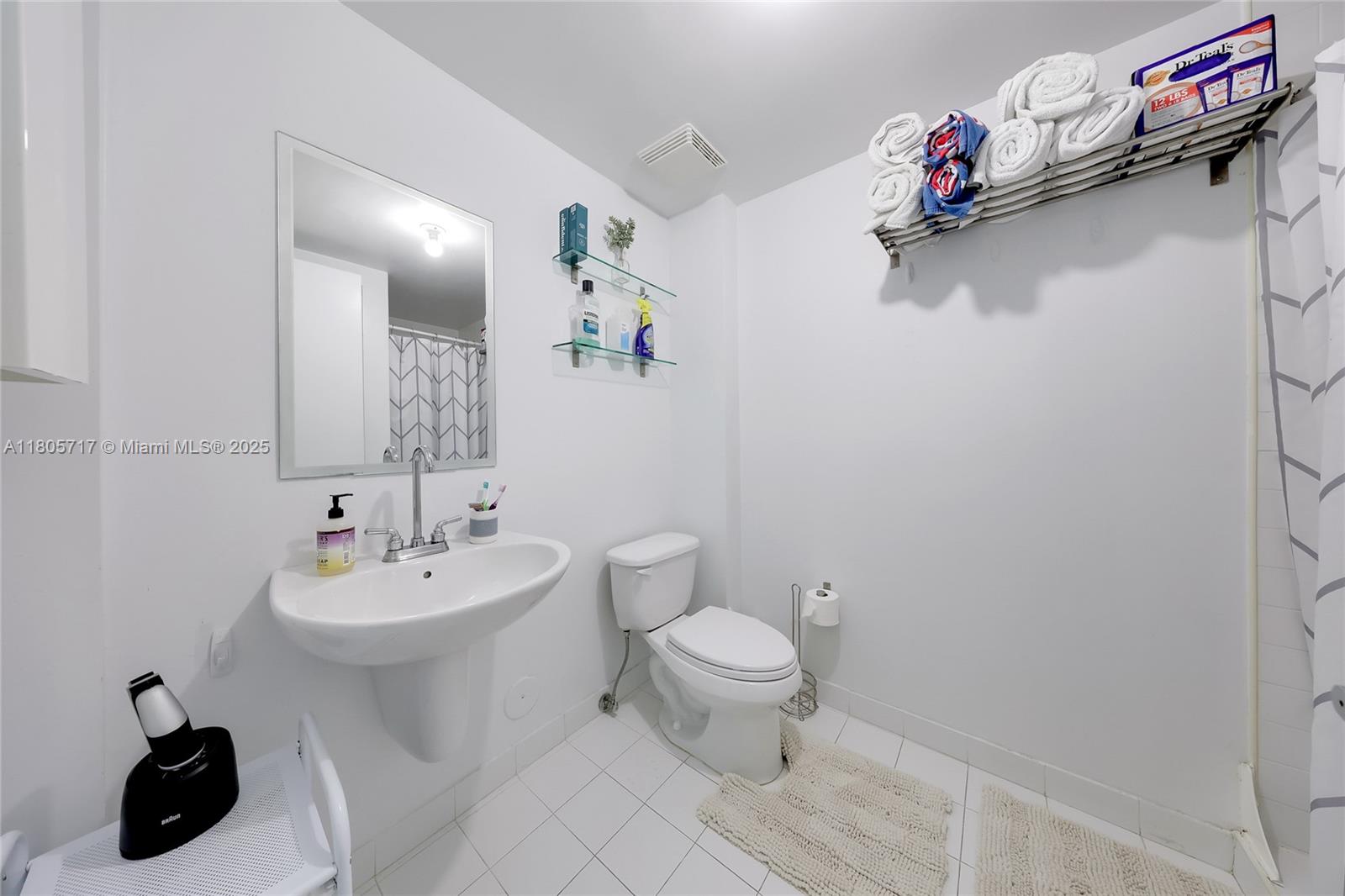 690 Southwest 1st Court, Unit 2109 Miami, FL 33130 - Photo 10 of 13 a bathroom with a sink mirror vanity and toilet