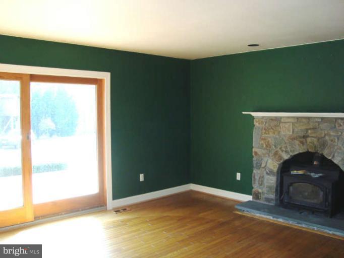 20535 Bucklodge Road Boyds, MD 20841 - Photo 11 of 30 a view of an empty room with a fireplace and a window