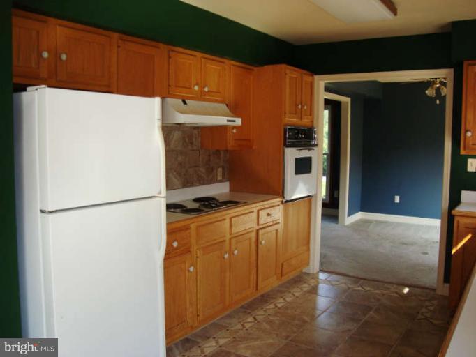 20535 Bucklodge Road Boyds, MD 20841 - Photo 9 of 30 a kitchen with stainless steel appliances a refrigerator and a sink