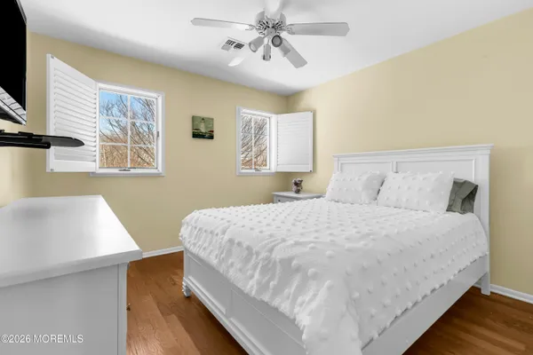 a bedroom with a bed and a night stand