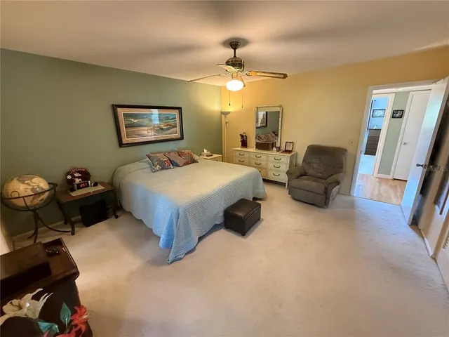 a bedroom with bed and a chandelier