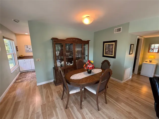 a dining room with furniture and wooden floor