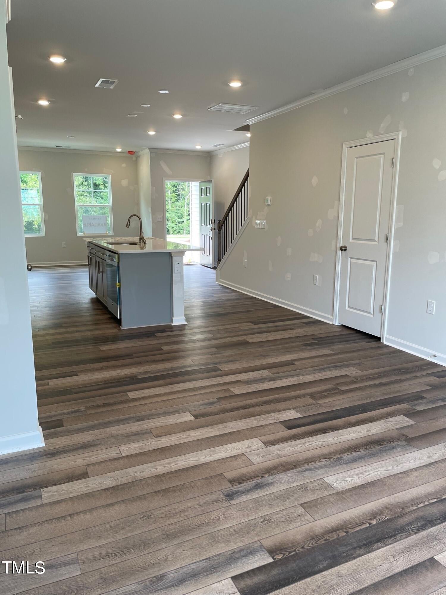 4921 Microcline Trail, Unit 790 Raleigh, NC 27610 - Photo 2 of 46 a view of kitchen and hall with wooden floor