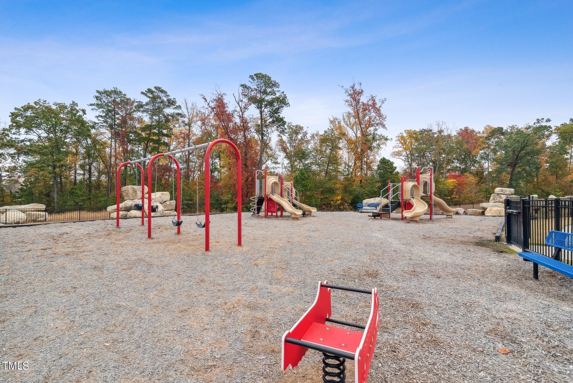 4921 Microcline Trail, Unit 790 Raleigh, NC 27610 - Photo 23 of 46 a view of park with swings and slides