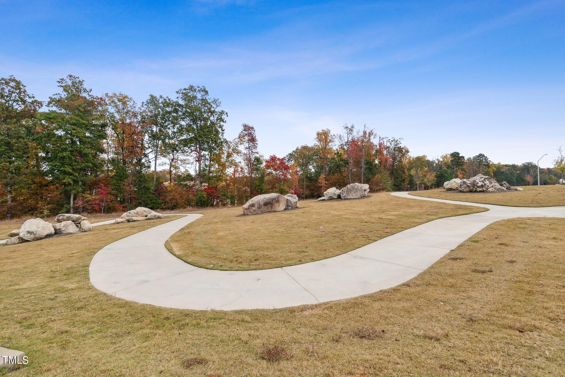 4921 Microcline Trail, Unit 790 Raleigh, NC 27610 - Photo 28 of 46 a view of a swimming pool with a yard