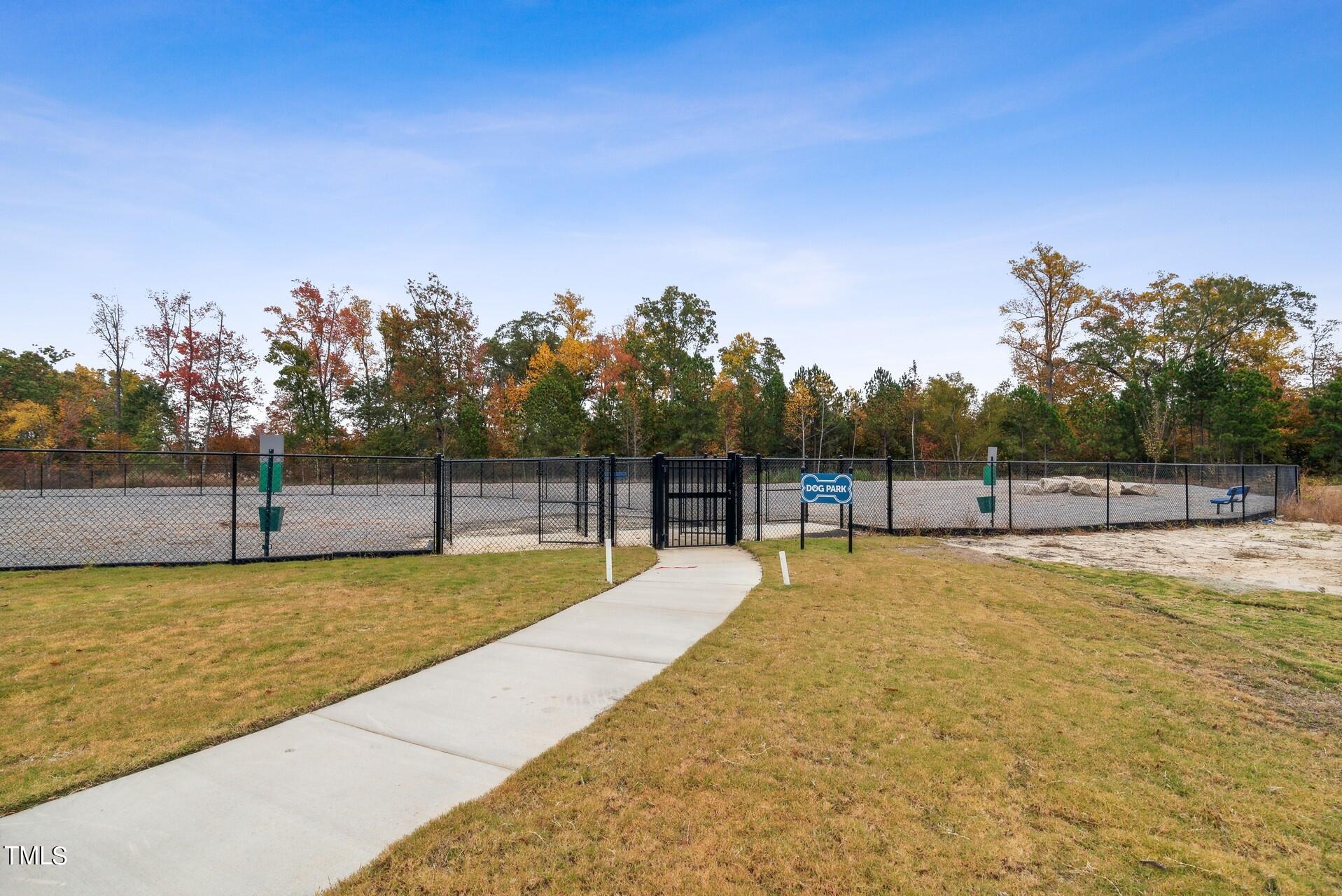 4921 Microcline Trail, Unit 790 Raleigh, NC 27610 - Photo 29 of 46 a swimming pool with trees in the background
