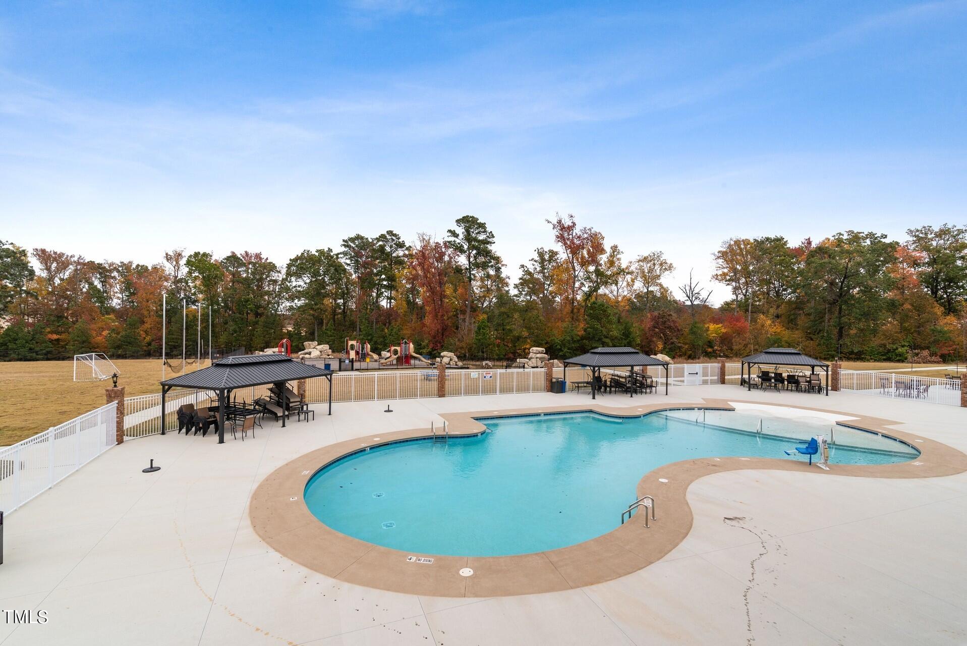4921 Microcline Trail, Unit 790 Raleigh, NC 27610 - Photo 36 of 46 a view of a swimming pool and lounge chairs