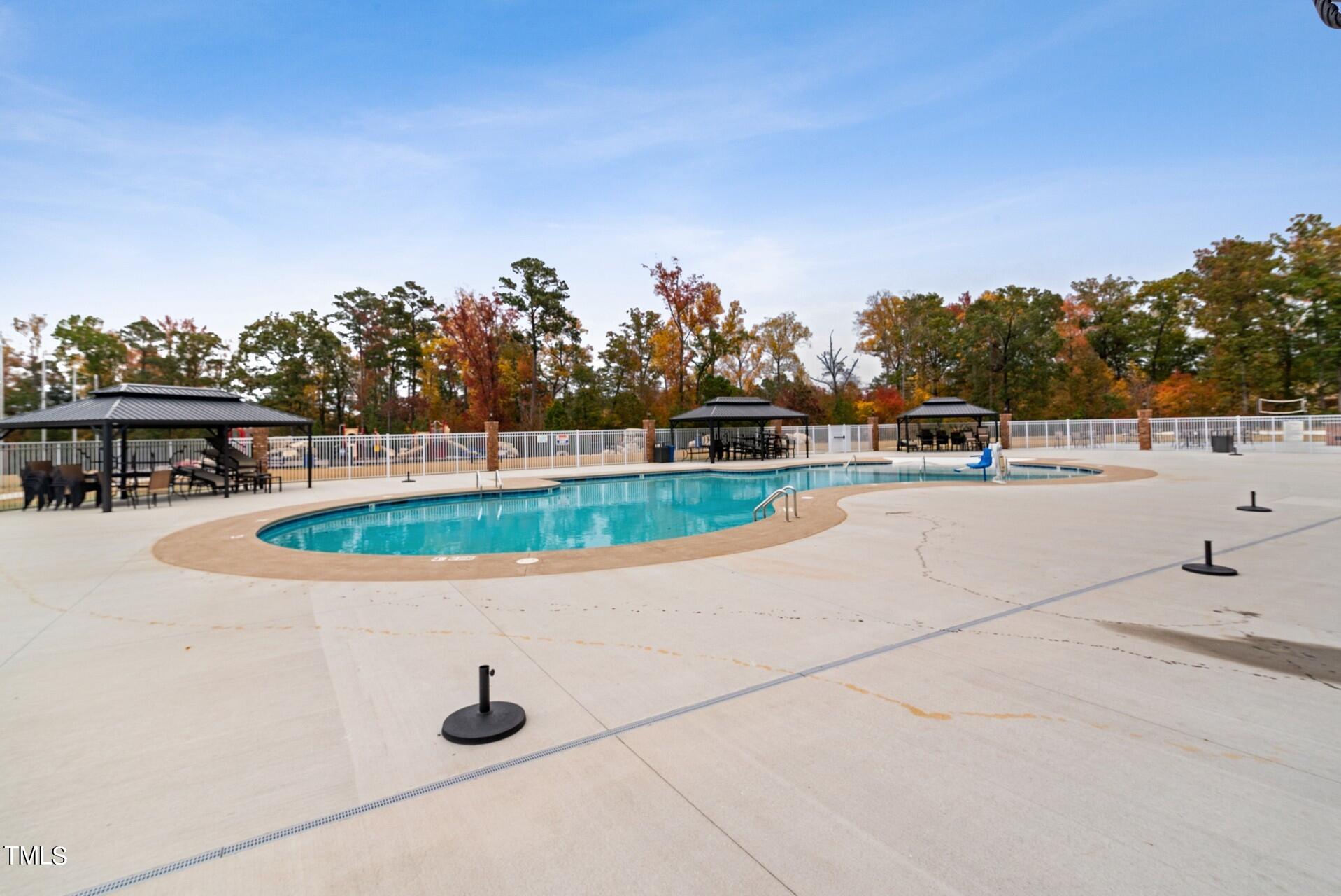 4921 Microcline Trail, Unit 790 Raleigh, NC 27610 - Photo 46 of 46 a view of a swimming pool with a yard