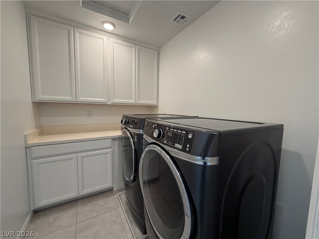 3228 Azalea Ridge Court Henderson, NV 89052 - Photo 23 of 28 Functional laundry room offers built-in cabinetry, practical countertops, and modern appliances.