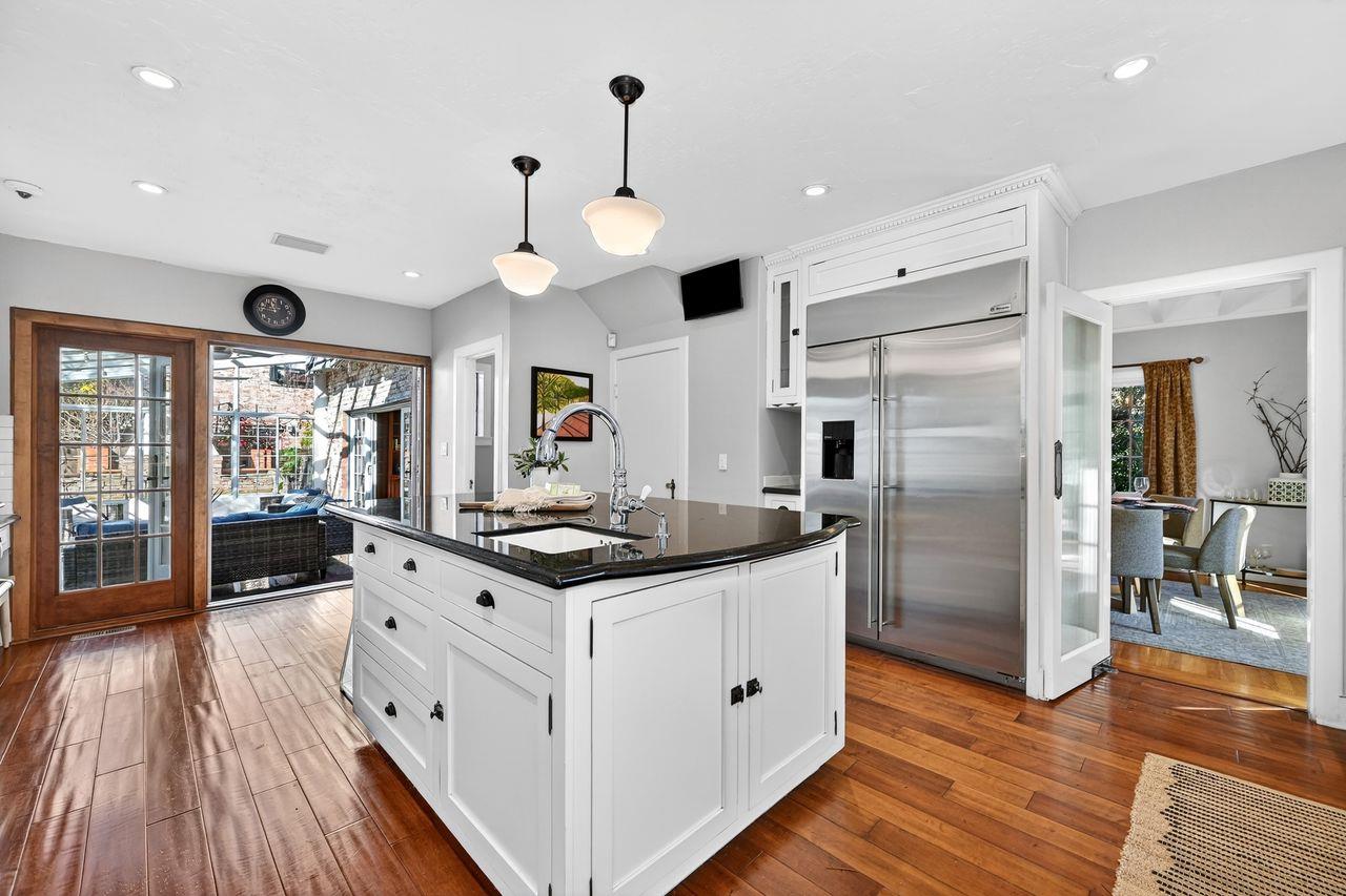 1716 Sutterville Road Sacramento, CA 95822 - Photo 16 of 57 a kitchen with stainless steel appliances a stove oven and a refrigerator with wooden floor
