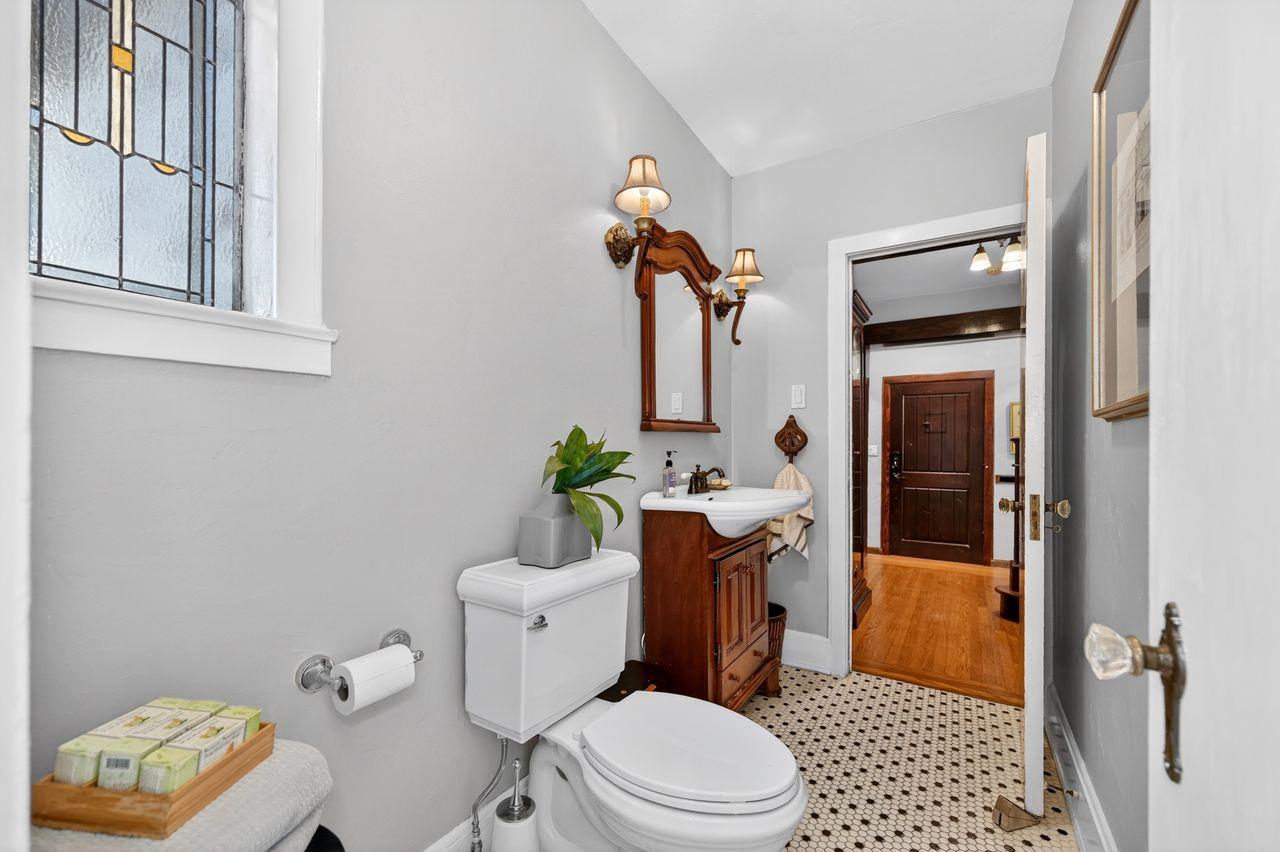 1716 Sutterville Road Sacramento, CA 95822 - Photo 25 of 57 a bathroom with a toilet a sink and mirror