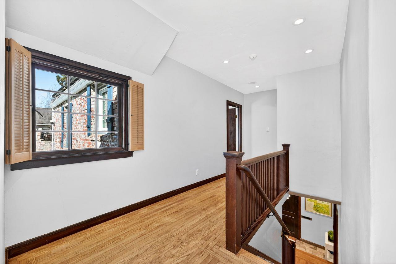 1716 Sutterville Road Sacramento, CA 95822 - Photo 27 of 57 a view of an empty room with wooden floor and windows