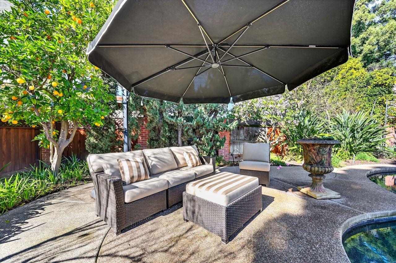 1716 Sutterville Road Sacramento, CA 95822 - Photo 45 of 57 a view of patio with a table and chairs under an umbrella