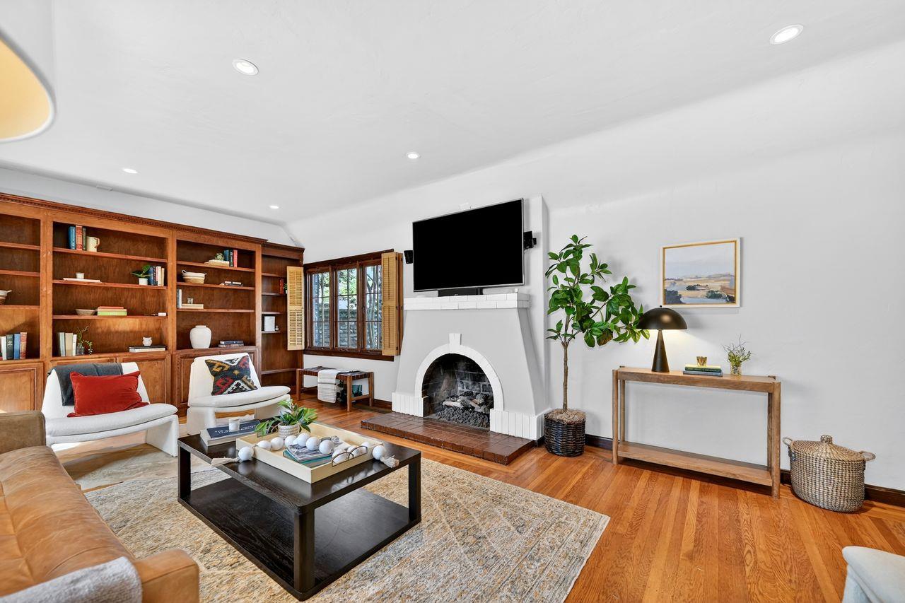 1716 Sutterville Road Sacramento, CA 95822 - Photo 8 of 57 a living room with furniture a fireplace and a flat screen tv