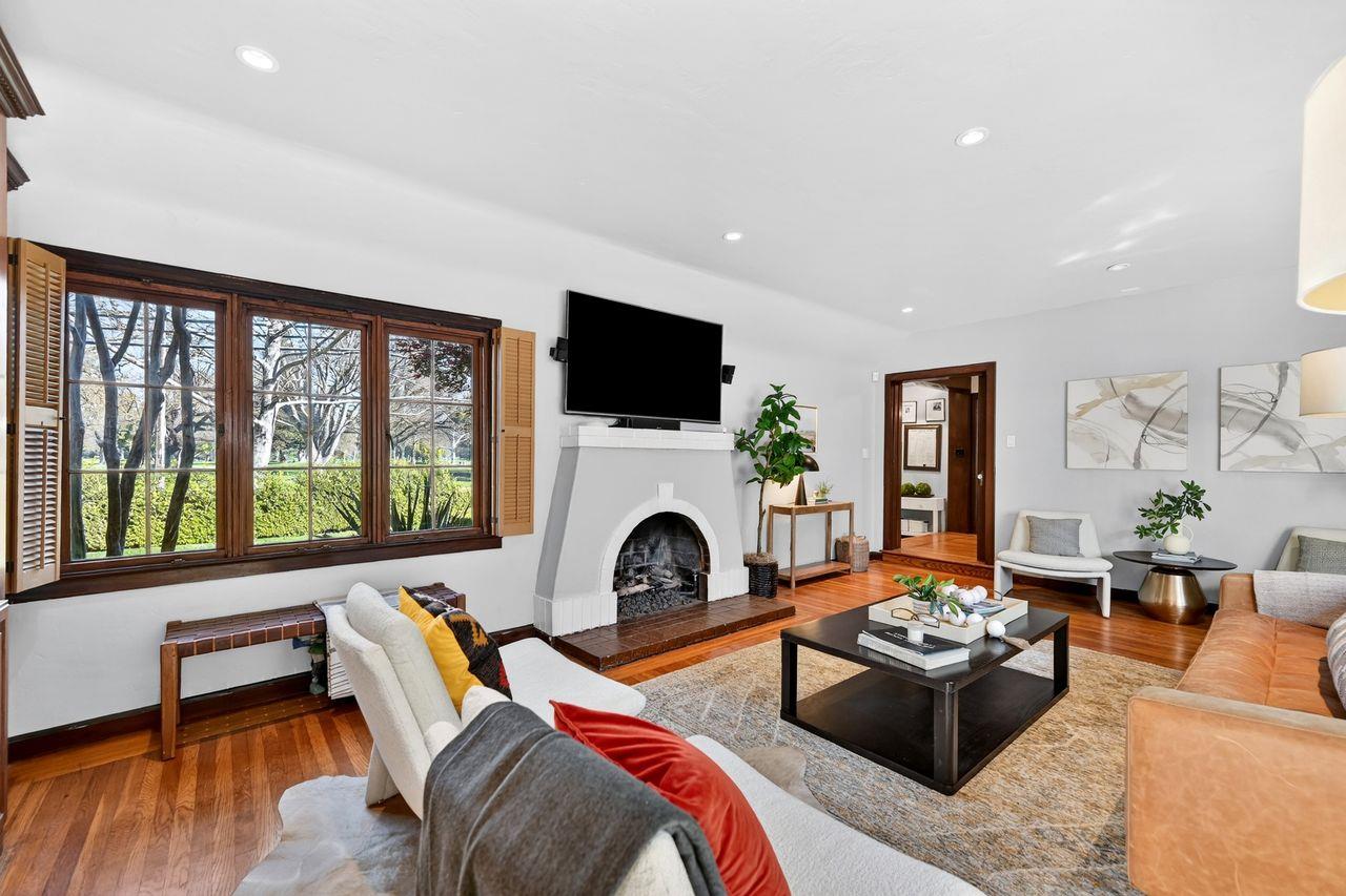 1716 Sutterville Road Sacramento, CA 95822 - Photo 9 of 57 a living room with furniture a fireplace and a flat screen tv