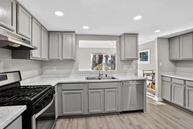 a kitchen with a sink stove and cabinets