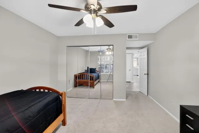 a room with furniture and a ceiling fan