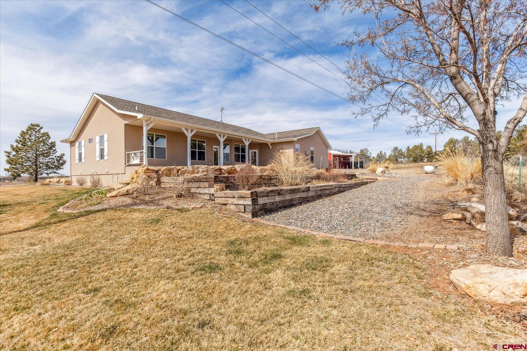 25583 Rd P Dolores, CO 81323 - Photo 25 of 34 a front view of a house with yard covered in snow