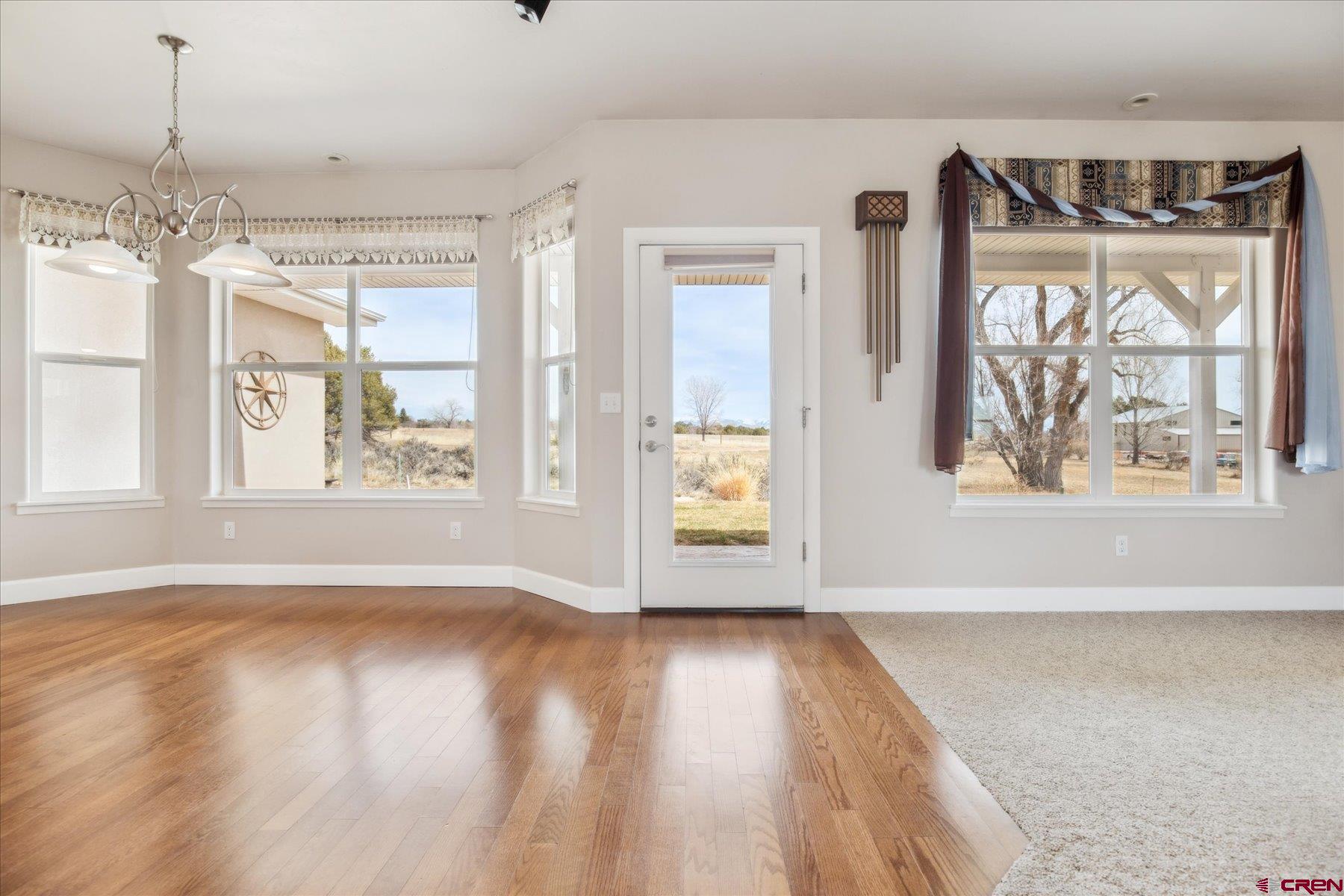 25583 Rd P Dolores, CO 81323 - Photo 8 of 34 a view of an empty room with wooden floor and a window
