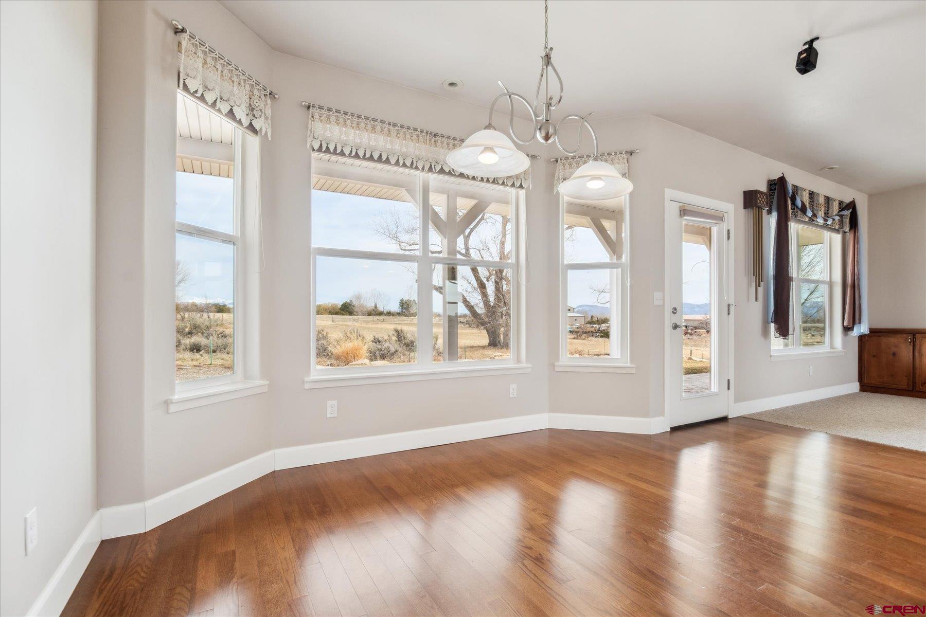 25583 Rd P Dolores, CO 81323 - Photo 9 of 34 a view of an empty room with wooden floor and a window